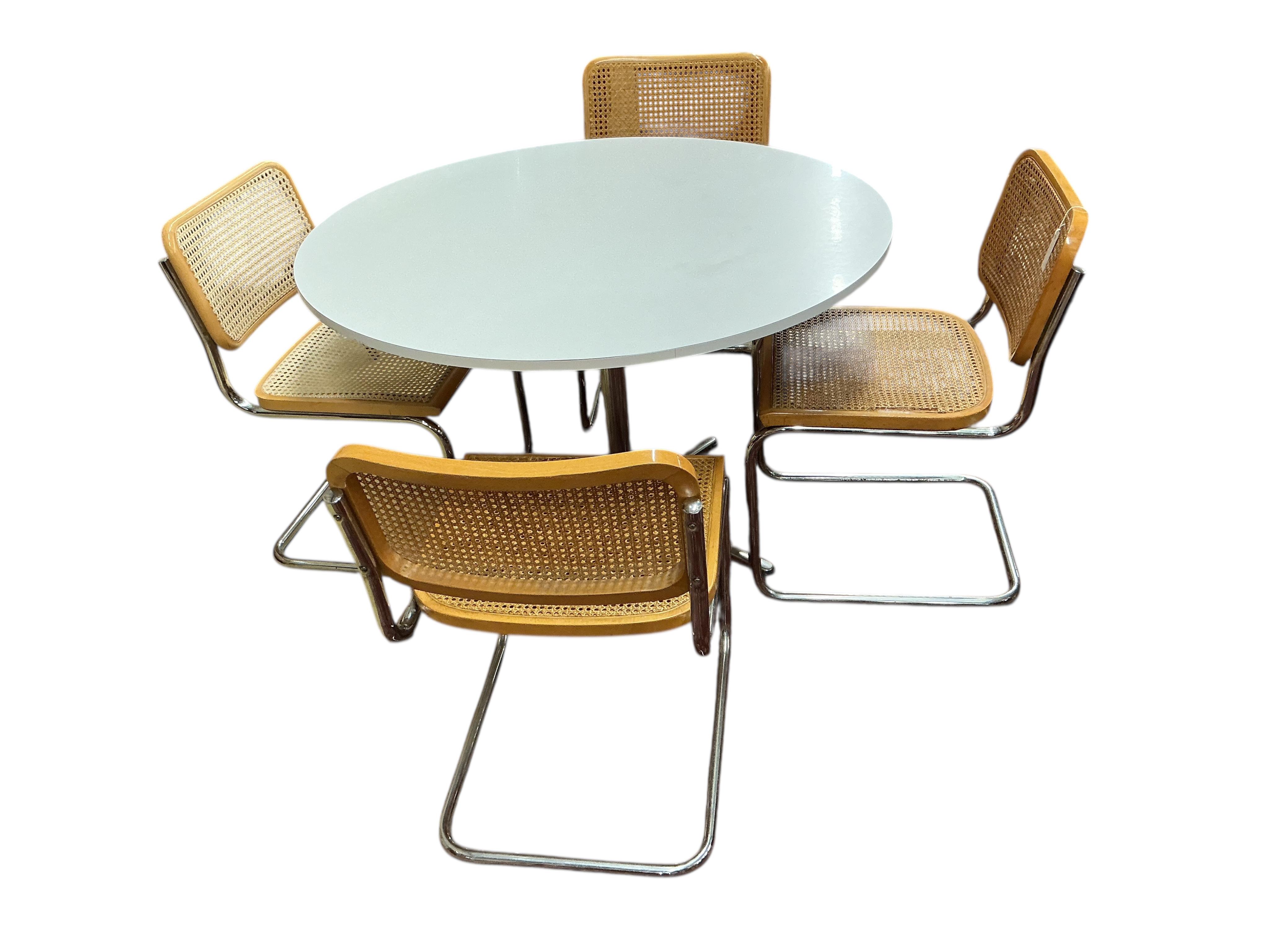 After Marcel Breuer a Cesca style circular table, diameter 112cm, height 72cm and four caned cantilever chairs, possibly Habitat.